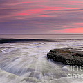 Coquina Rocks Washed by Ocean Waves At Colorful Sunset